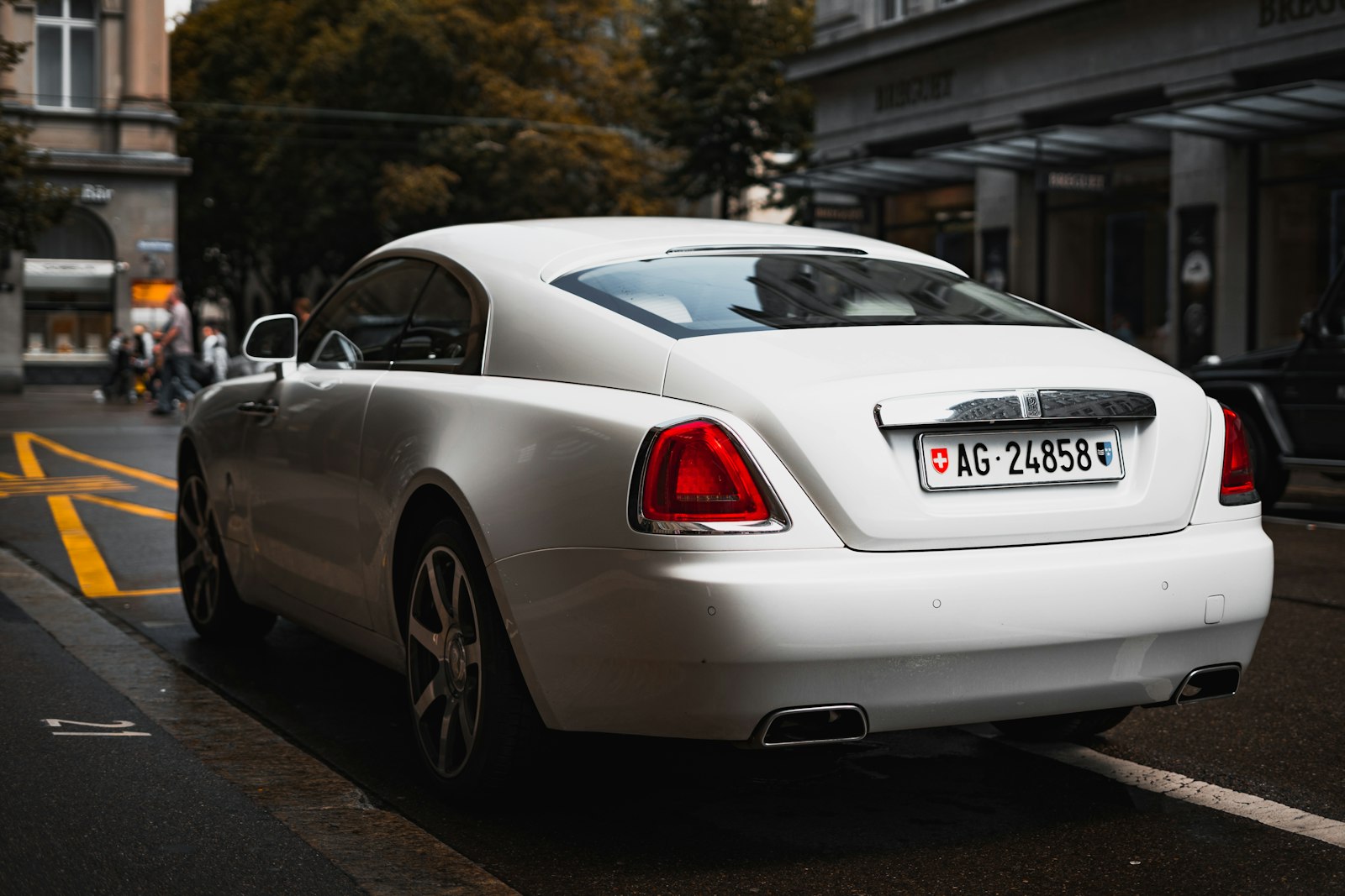 White Rolls-Royce coupe parked on a city street