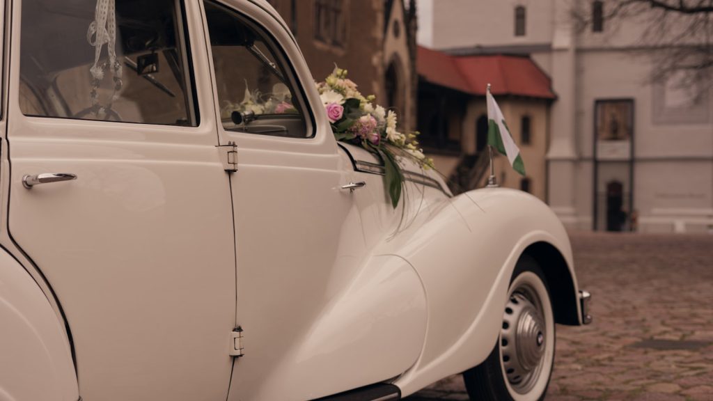 a white car with flowers on the side of it
